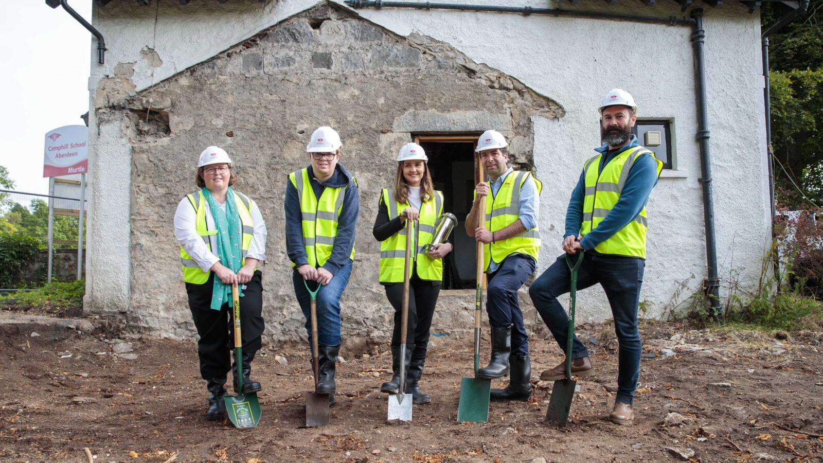Scotland’s Cabinet Secretary for Net Zero Màiri McAllan MSP helps to bury a time capsule containing wishes on the site of new social enterprise Murtle Market, part of Camphill School Aberdeen's ambitious expansion plans.